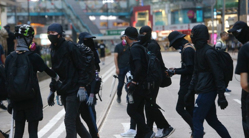 Young protesters wearing black and masks join an anti-government protesters to take to the streets in downtown Causeway Bay, Hong Kong, on Sunday Sep 15, 2019 during a banned demonstration to press their demands on investigating police abuse of power against protesters and universal suffrage of the Chief Executive and legislature. (James Lee/EYEPRESS)