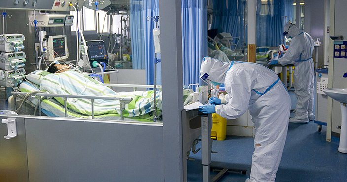 FILE - In this Jan. 24, 2020, file photo released by China's Xinhua News Agency, a medical worker attends to a patient in the intensive care unit at Zhongnan Hospital of Wuhan University in Wuhan in central China's Hubei Province. As Beijing instates one of the largest quarantines in modern history, locking down over 50 million people in Hubei province, questions are swirling around the provincial government's sluggish initial response. (Xiong Qi/Xinhua via AP, File)